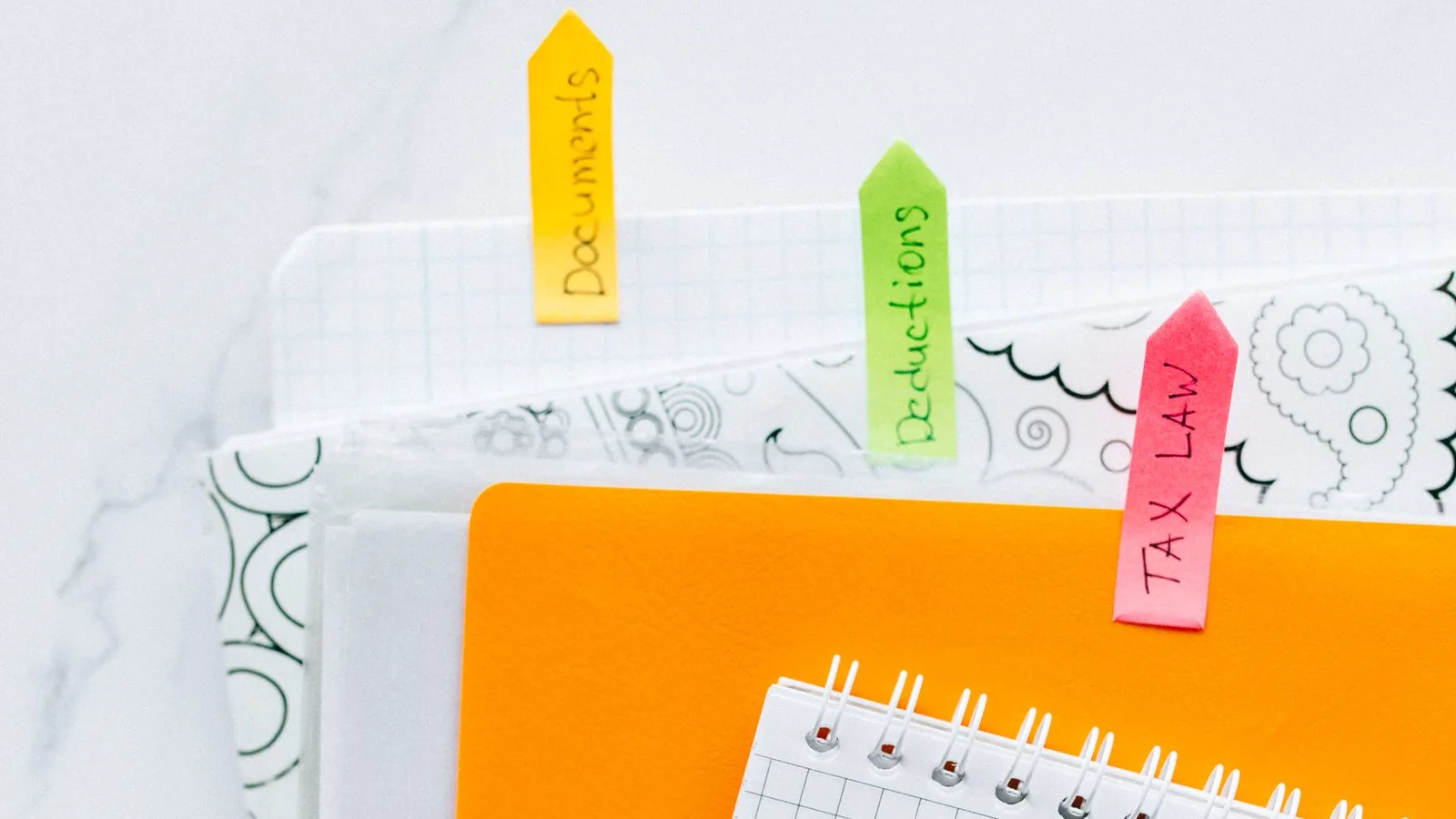 Labeled folders and a notebook used to organize tax documents