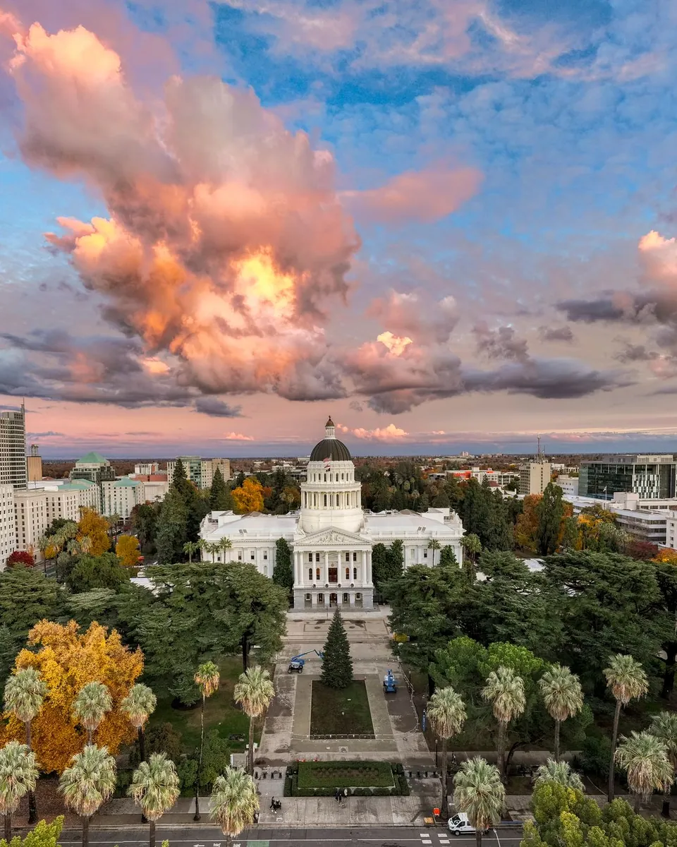 California State Capitol and Capitol Park under sunset clouds in Sacramento, CA
