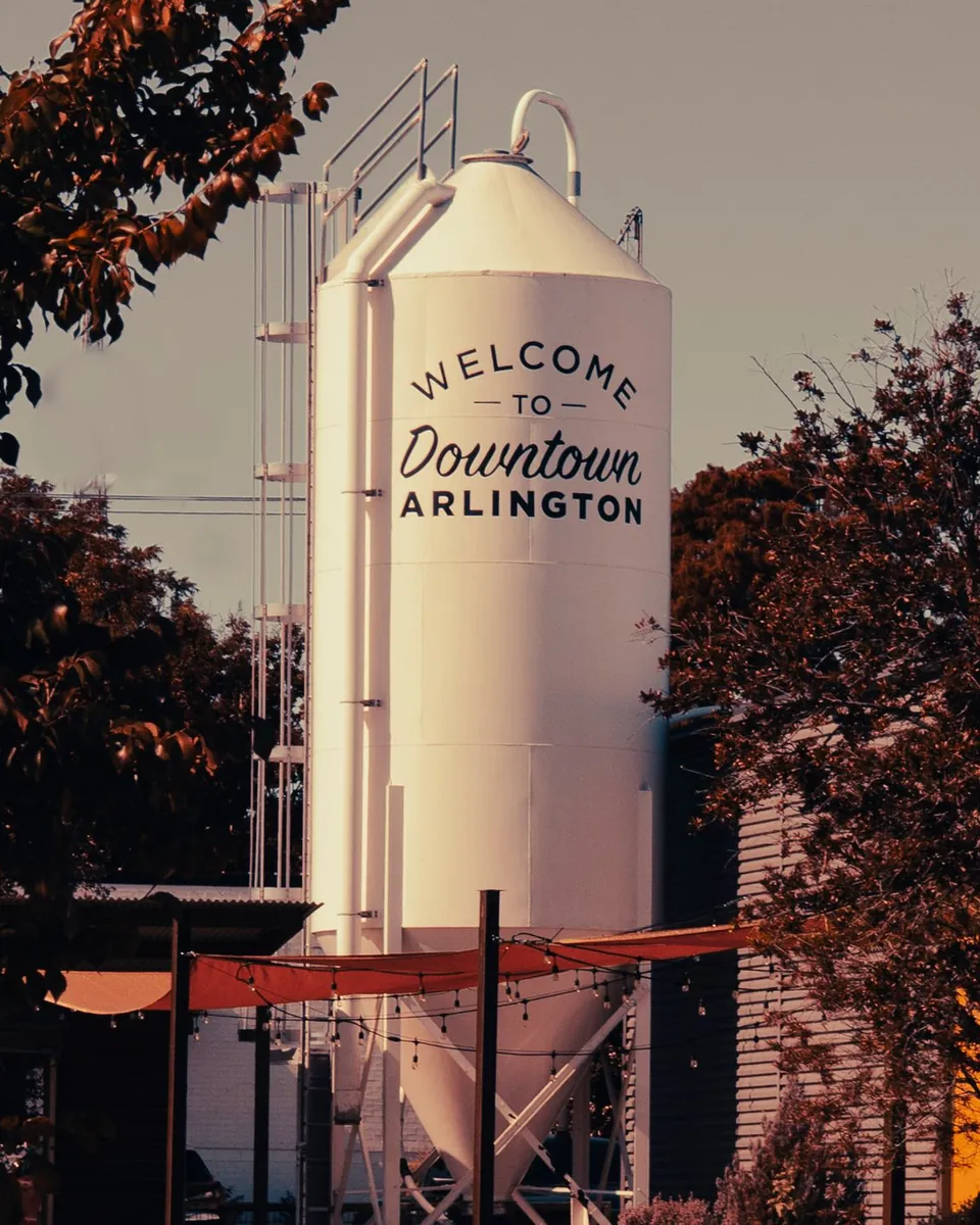 Welcome to Downtown Arlington silo in Arlington, TX framed by autumn trees
