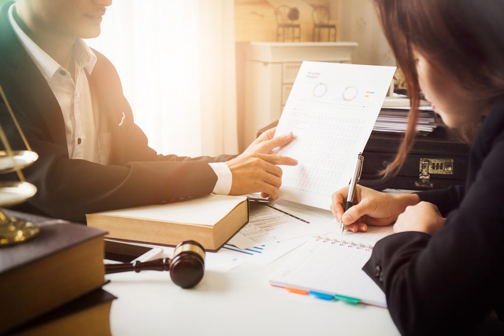 Consultation between a tax attorney and client discussing financial situation  